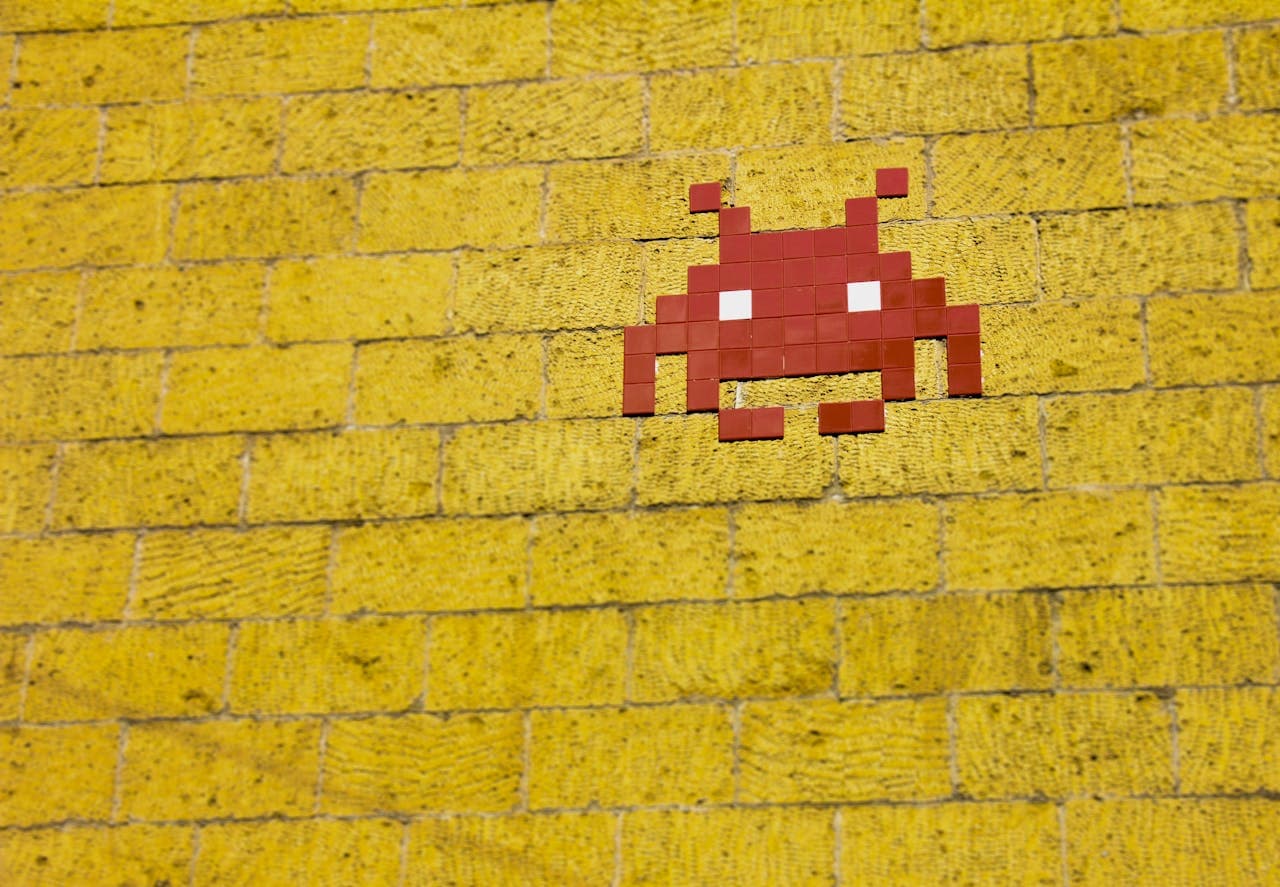 Space Invader pixel art on a yellow wall