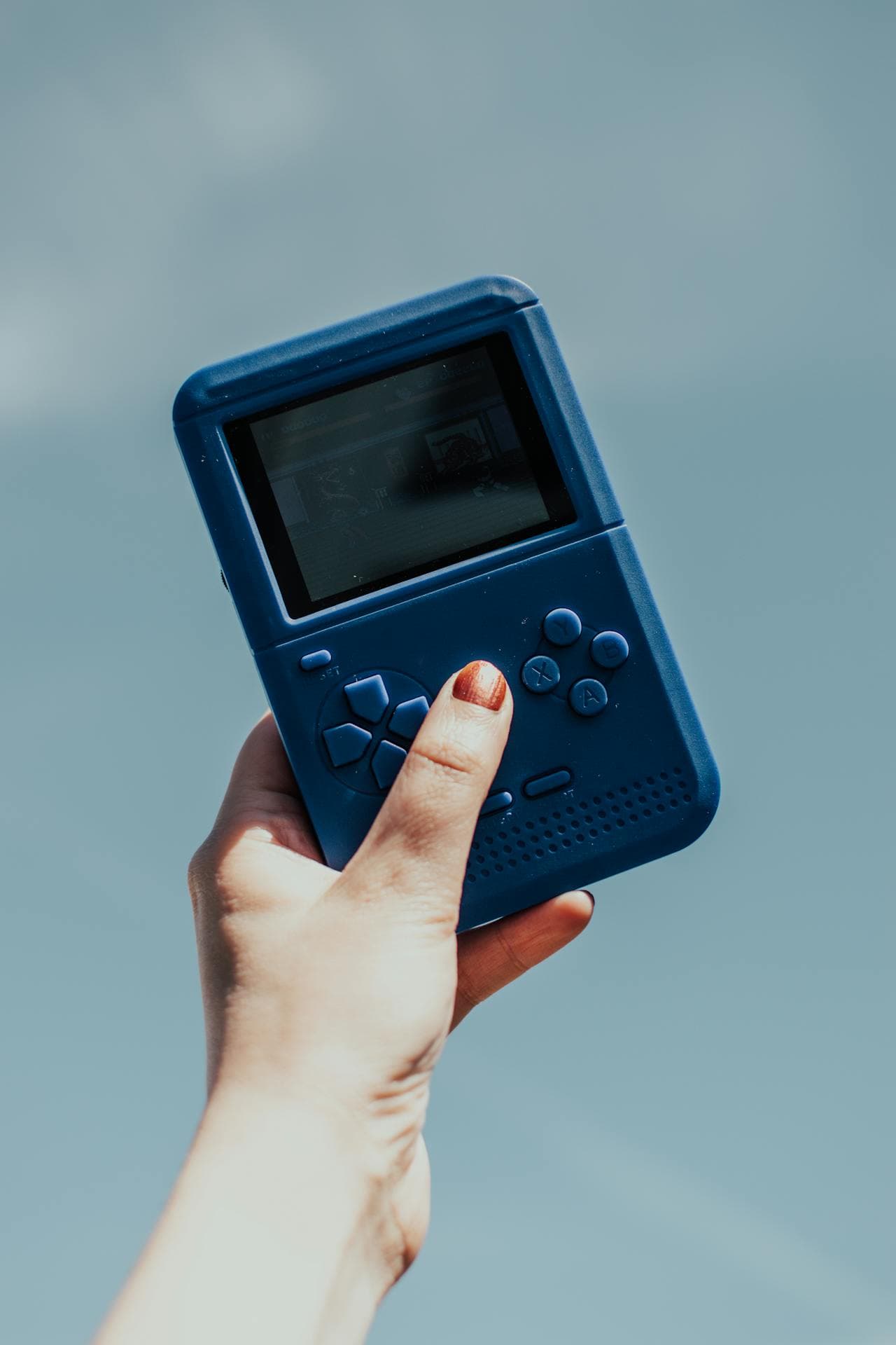 Hand holding a retro handheld console