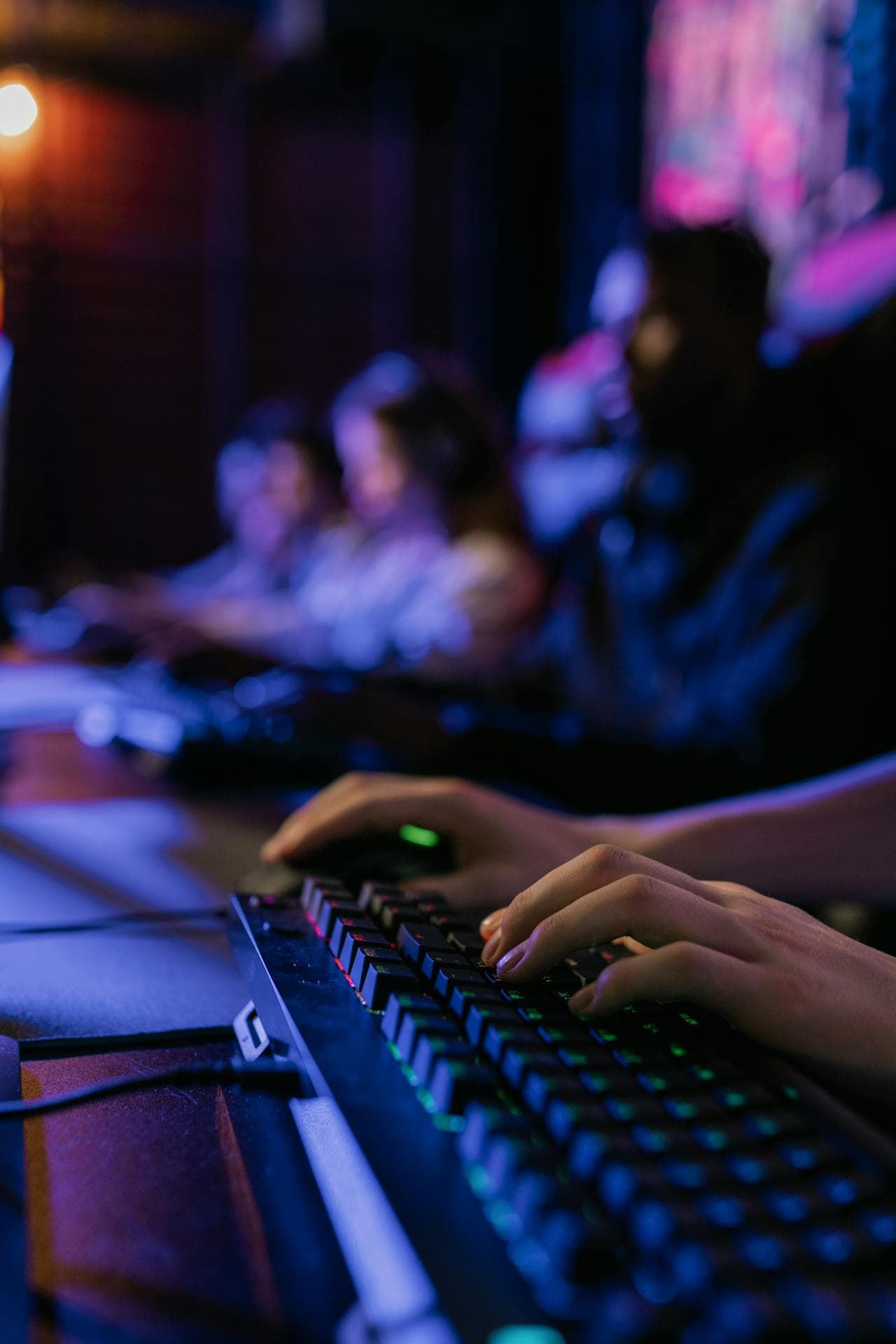 Gamer at a backlit mechanical keyboard